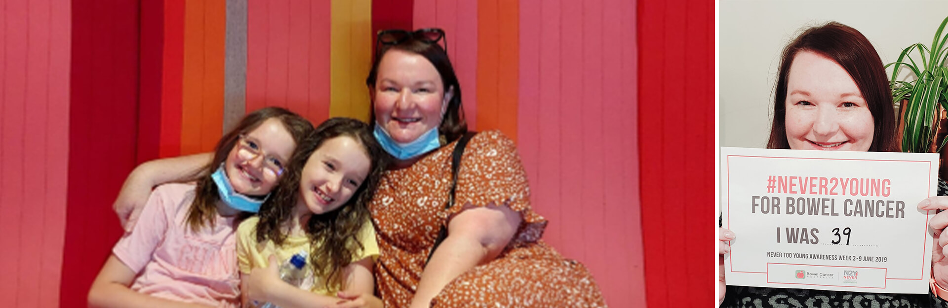 A woman sits with two children, all smiling, against a colorful striped background. The woman holds a sign about bowel cancer awareness.