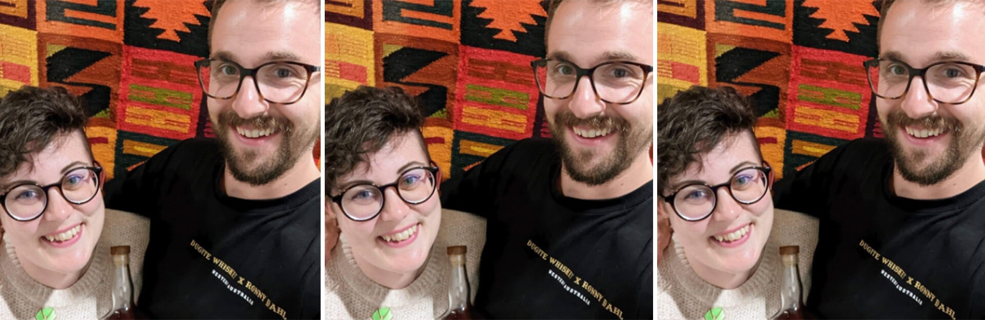 A smiling couple poses for a selfie in front of a colorful patterned background.
