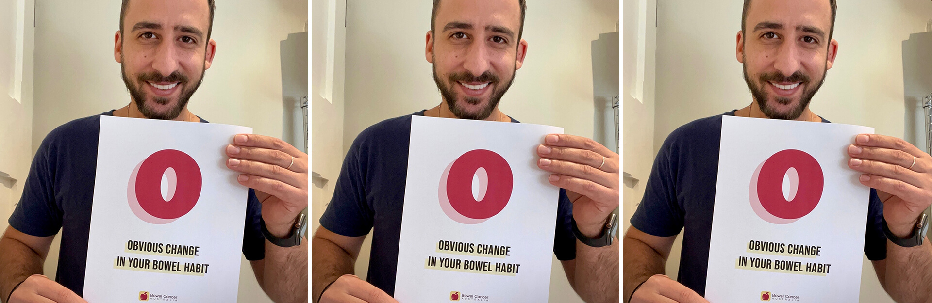 A man smiles while holding a sign that reads "OBVIOUS CHANGE IN YOUR BOWEL HABIT" with a large red "O."