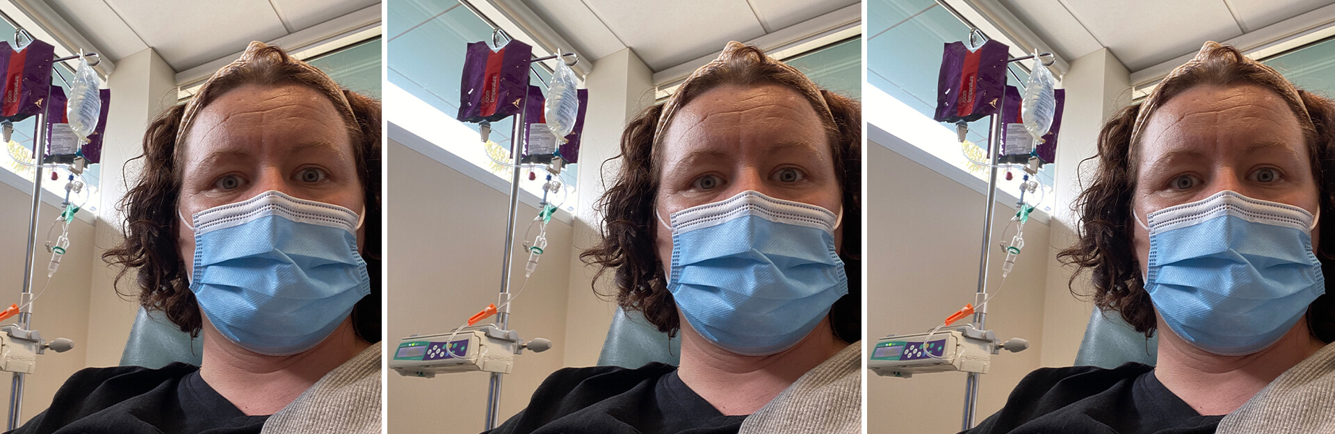 A person wearing a blue mask sits in a hospital room with IV equipment visible in the background.
