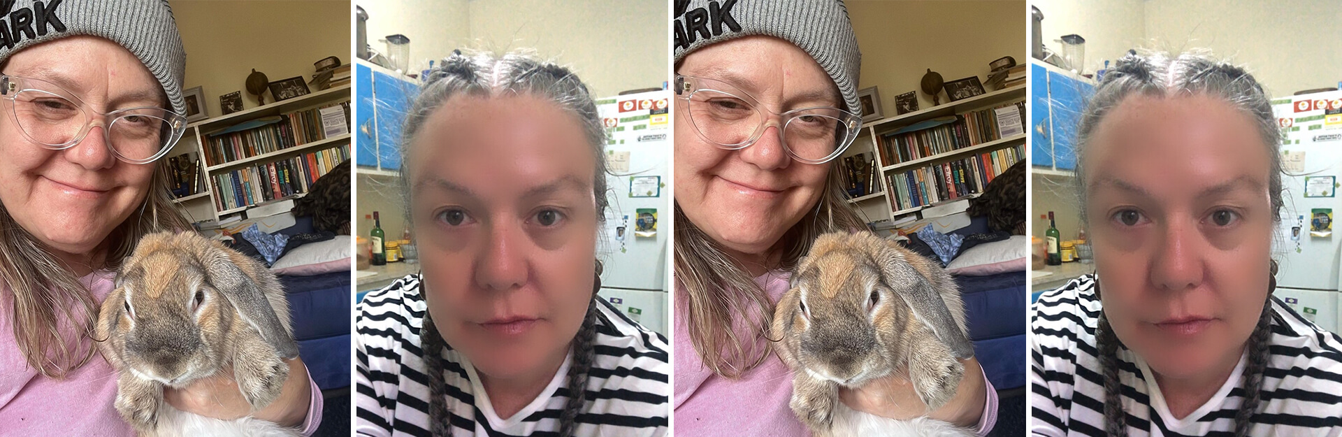 A person wearing a gray beanie holds a rabbit, smiling, with a bookshelf in the background.