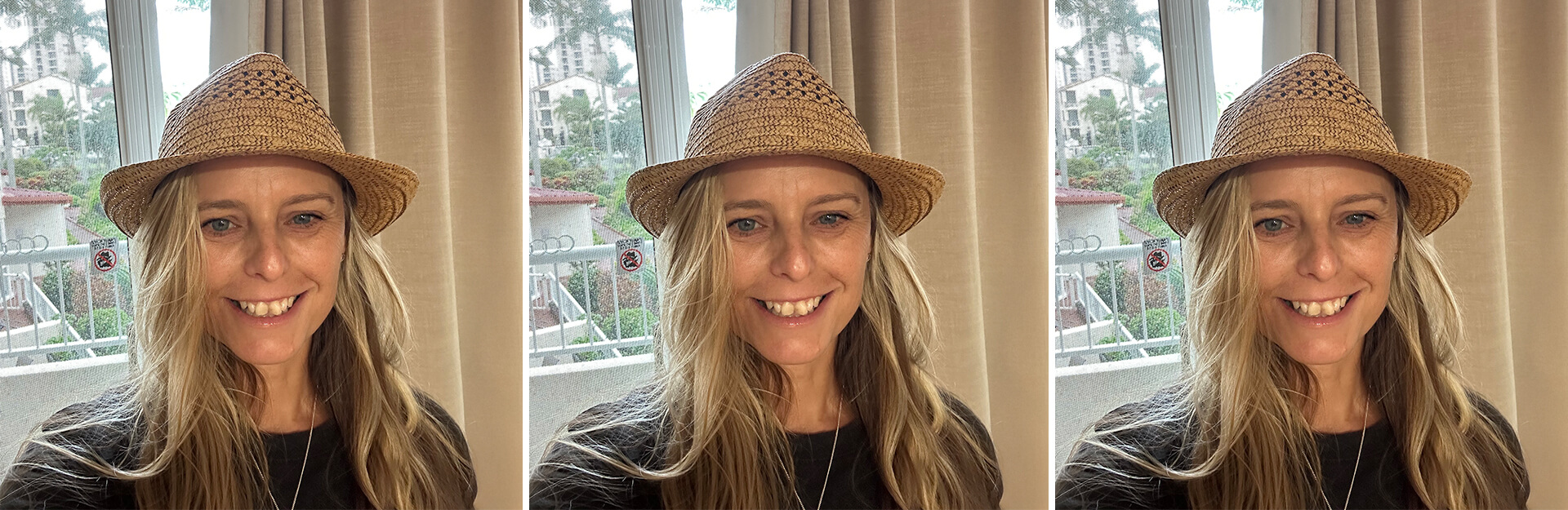 A woman with long hair wearing a straw hat smiles in front of a window with greenery visible outside.