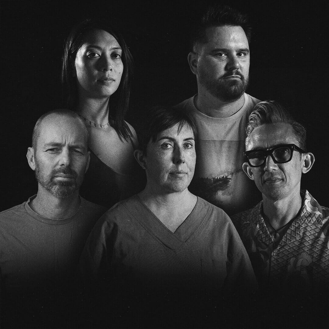 Five individuals in a monochrome portrait, arranged in a group with serious expressions against a dark background.