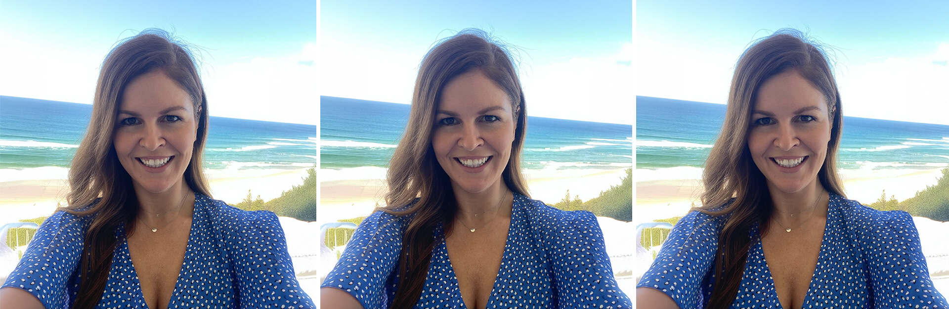 A woman in a blue polka dot dress smiles at the camera with a beach and ocean in the background.