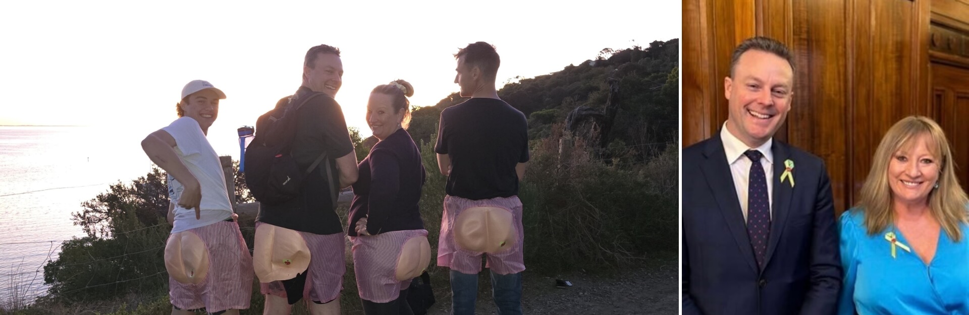 A group of people wearing pink shorts with a humorous design, standing by a scenic view at sunset.