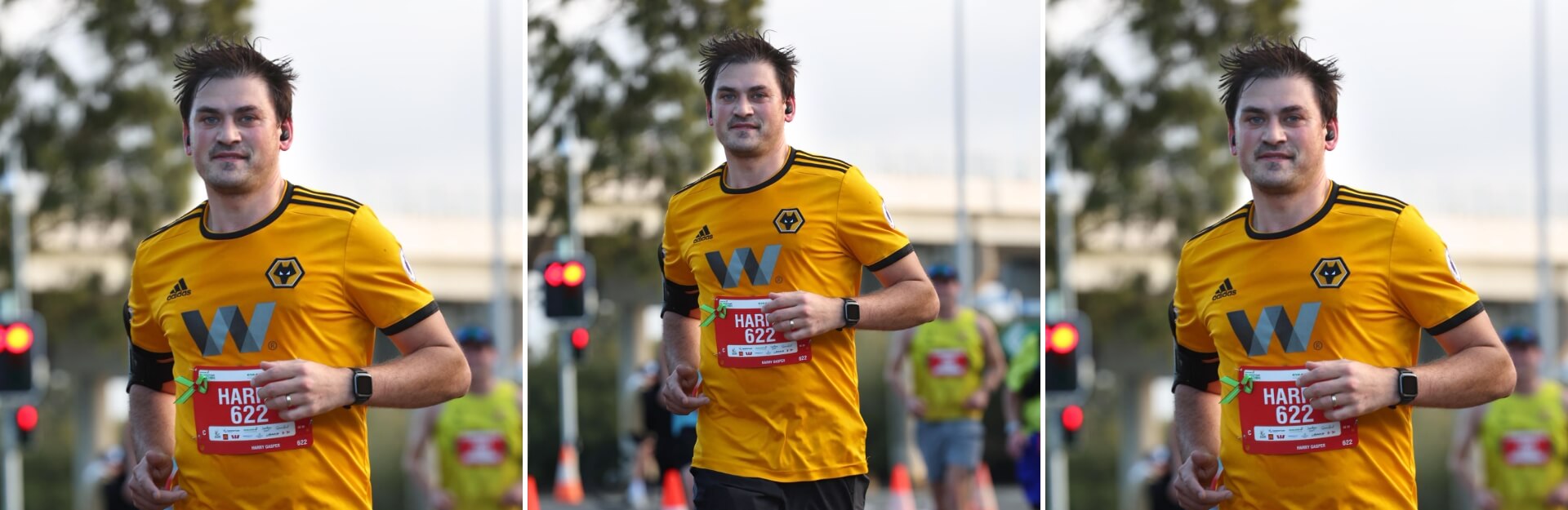 A runner in a yellow shirt with black accents smiles while participating in a race, wearing a bib number 622.