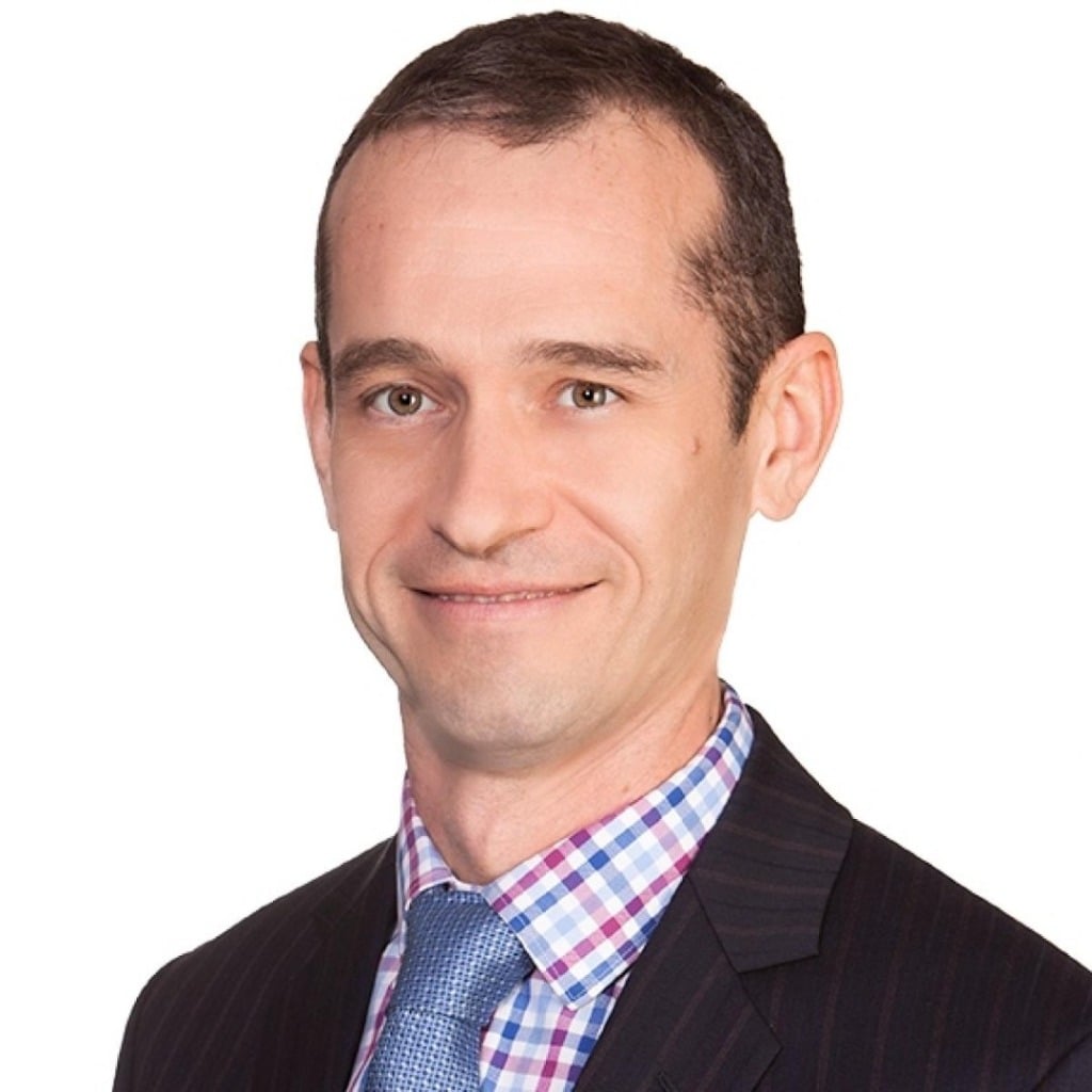 Professional headshot of a man in a suit, representing the early-onset bowel cancer centre of research excellence.