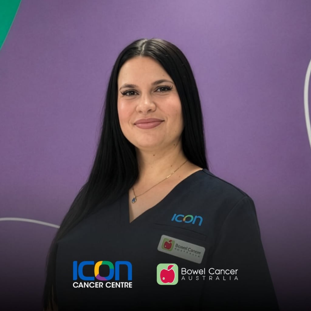 A woman with long black hair smiles, wearing a dark uniform with "ICON" and a name badge, against a purple background.