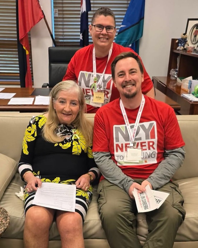 Three advocates pose for a photo in a government office, promoting Call on Canberra early-onset bowel cancer advocacy.