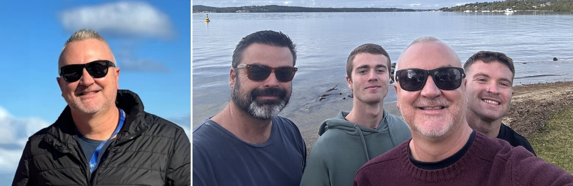A man with sunglasses smiles against a blue sky, alongside three men by a calm water body.