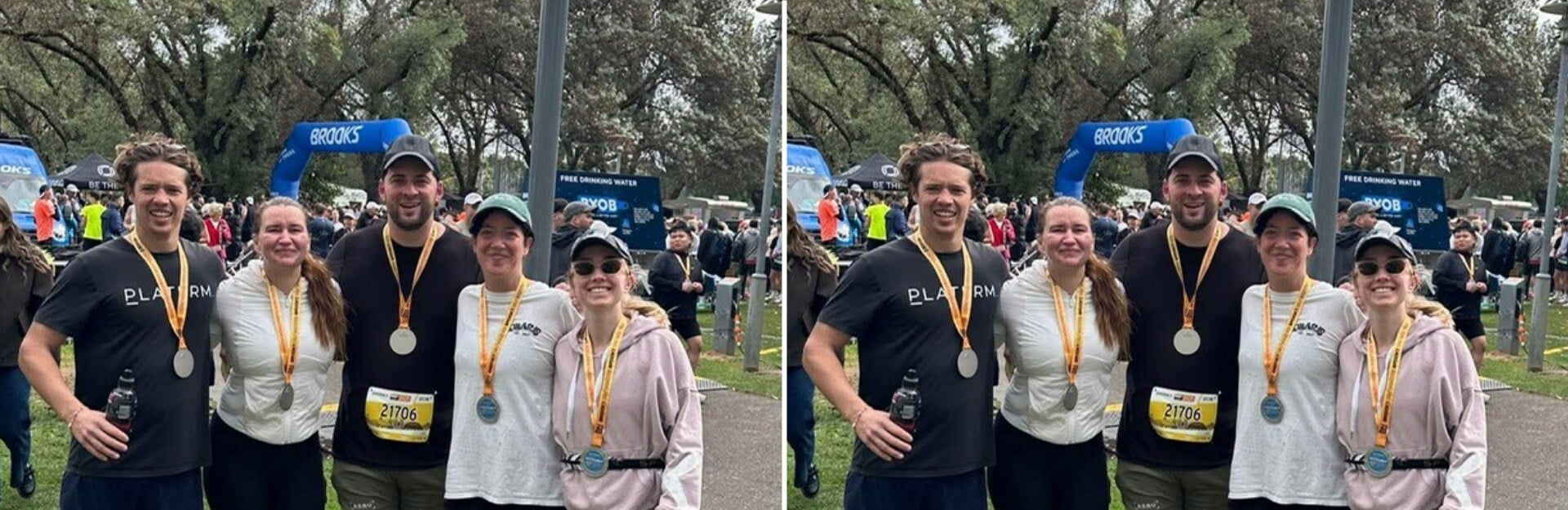 Four participants pose with medals after a race, with a crowd and event signage in the background.